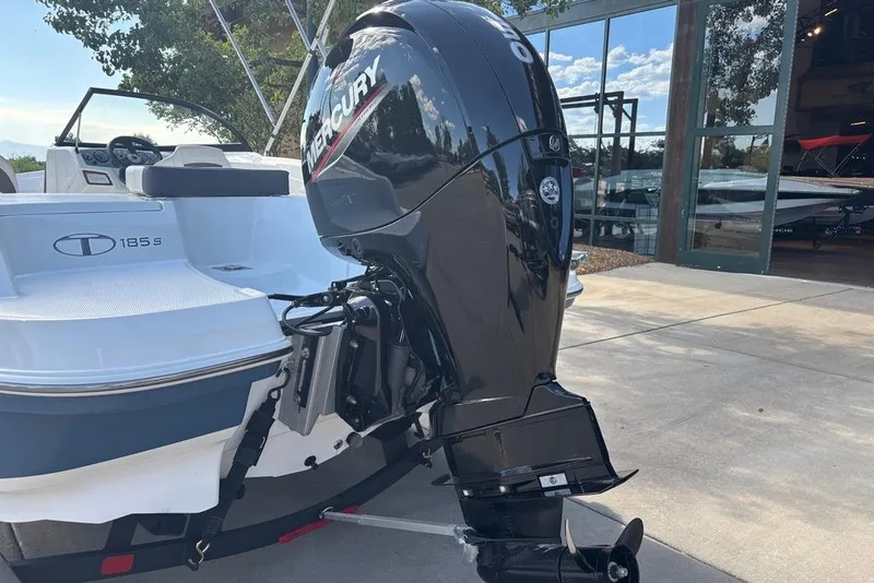 Slide: The Image of 2024 Tahoe 185 S boat with Mercury outboard motor, parked outdoors. - 14