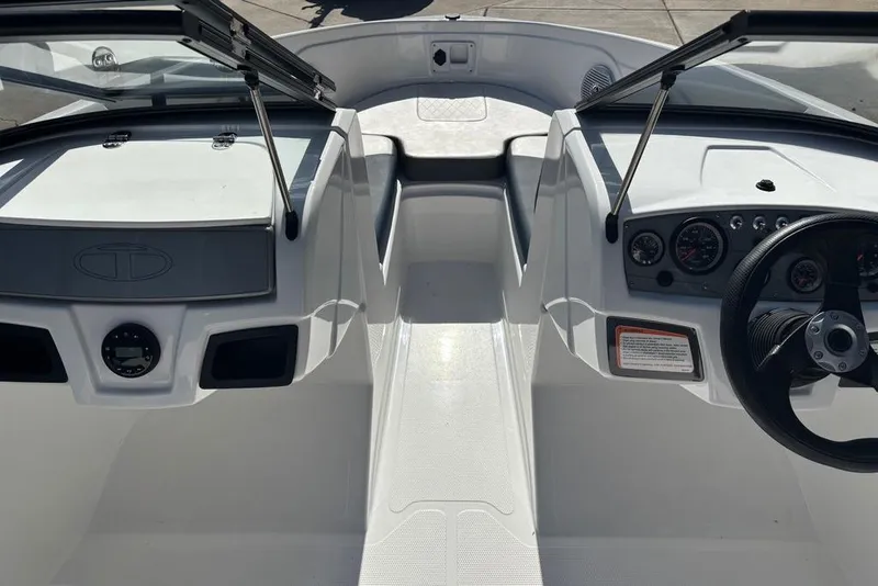 Slide: The Image of 2024 Tahoe 185 S boat interior with steering wheel and dashboard controls. - 4