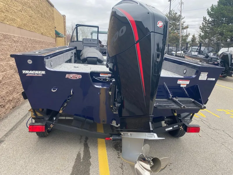 Slide: The Image of 2024 Tracker Targa V-18 WT boat with powerful outboard motor, parked outdoors. - 2