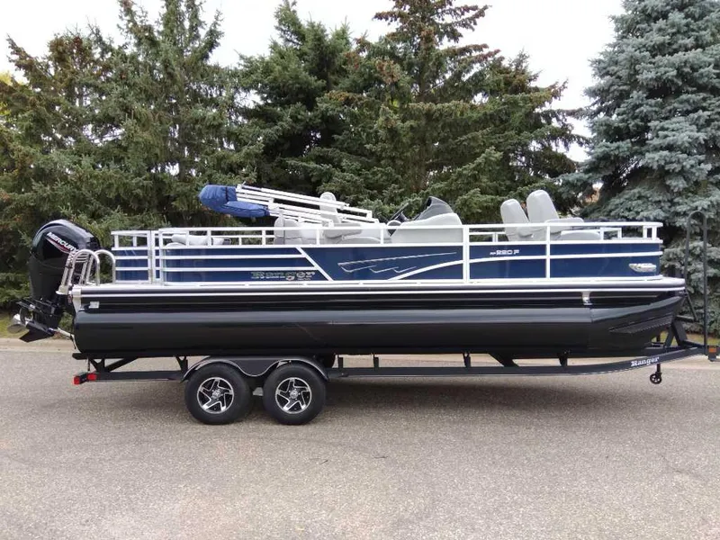 The Image of 2024 Ranger Reata 220F pontoon boat on trailer, parked outdoors. - 0