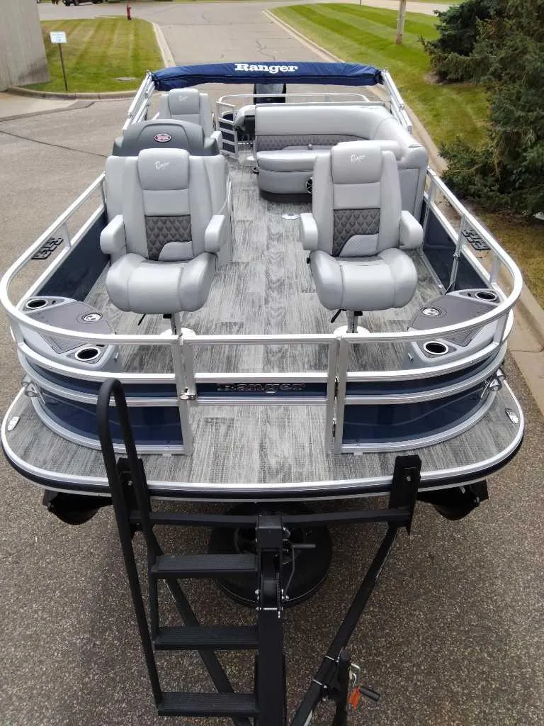 Slide: The Image of 2024 Ranger Reata 220F pontoon boat with gray seating and sleek design. - 1