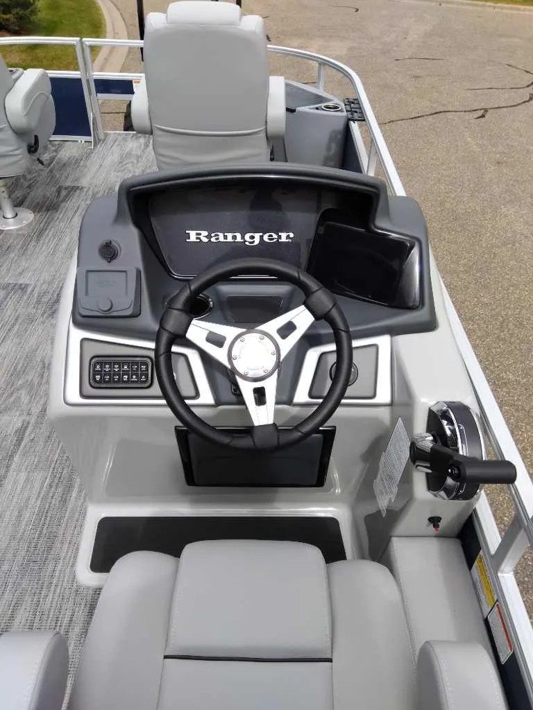 Slide: The Image of 2024 Ranger Reata 220F boat dashboard with steering wheel and controls. - 3