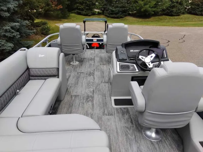 Slide: The Image of 2024 Ranger Reata 220F pontoon boat interior with gray seating and steering console. - 4