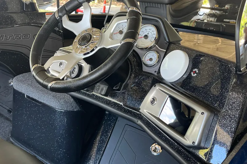 Slide: The Image of 2024 Nitro ZV20 boat dashboard with steering wheel and gauges. - 9