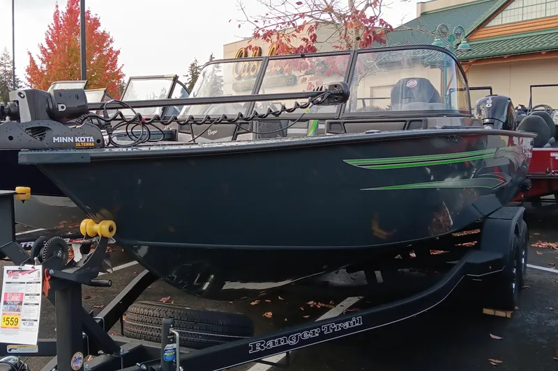 The Image of 2024 Ranger VX1988 WT fishing boat on trailer, displayed outdoors with autumn foliage. - 0