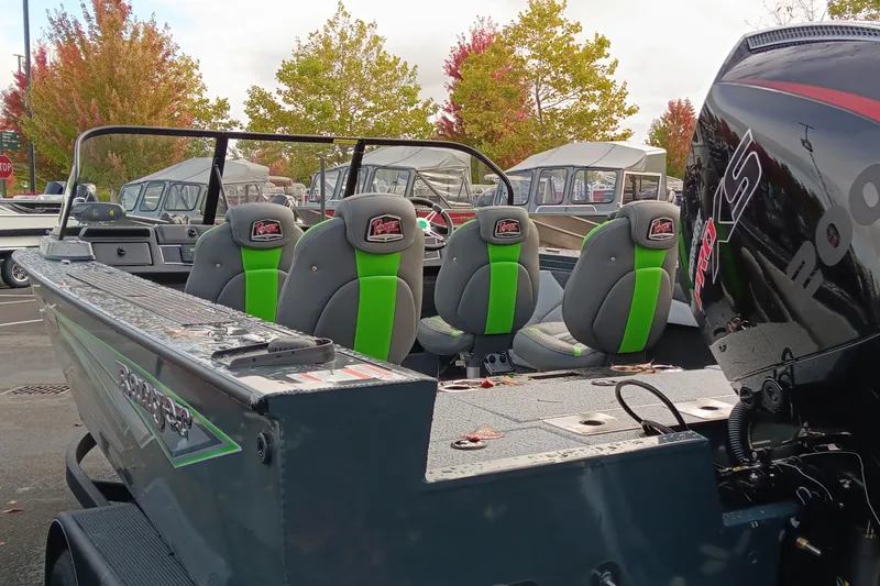 Slide: The Image of 2024 Ranger VX1988 WT boat with green-accented seats and powerful outboard motor. - 3