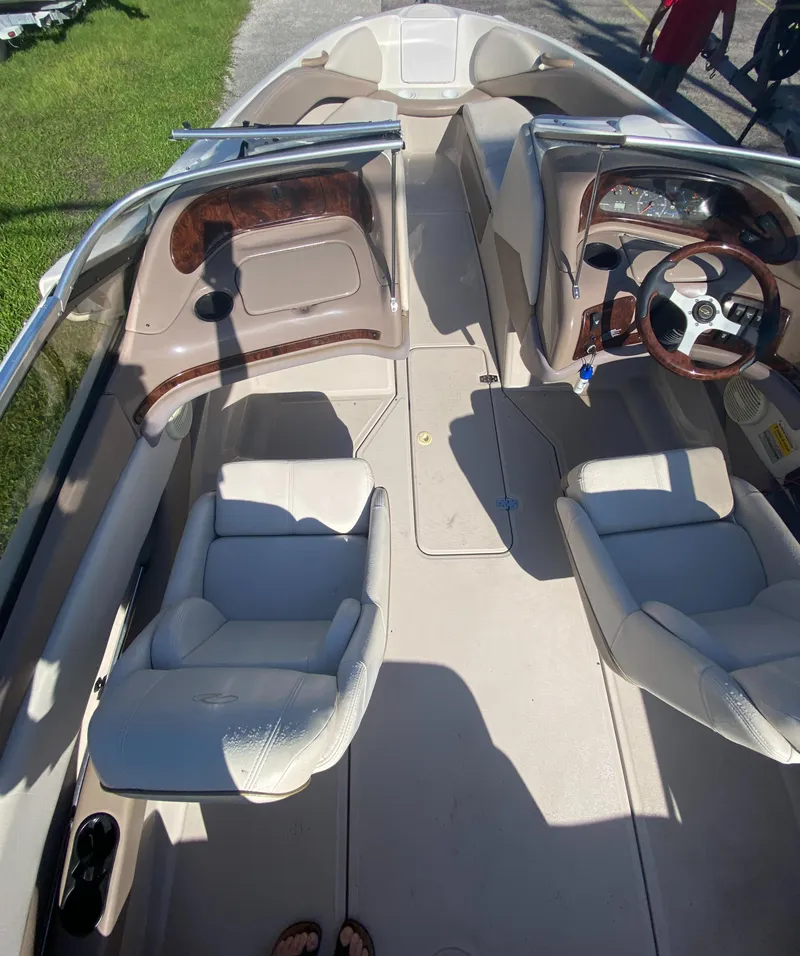 Slide: The Image of 2002 Regal 1900 LSR boat interior with beige seating and wood accents. - 10