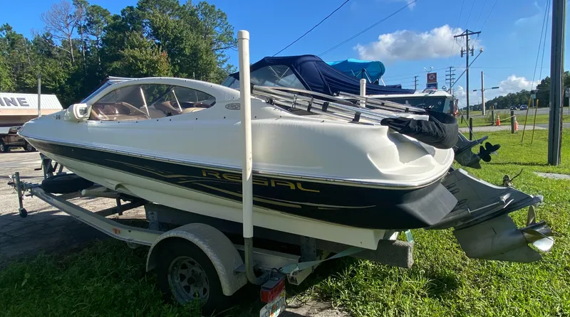 Slide: The Image of 2002 Regal 1900 LSR boat on trailer, parked outdoors on grass. - 12