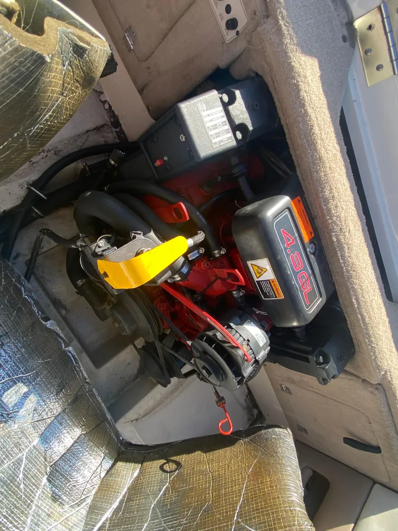 Slide: The Image of 2002 Regal 1900 LSR boat engine compartment with visible components and seating. - 4