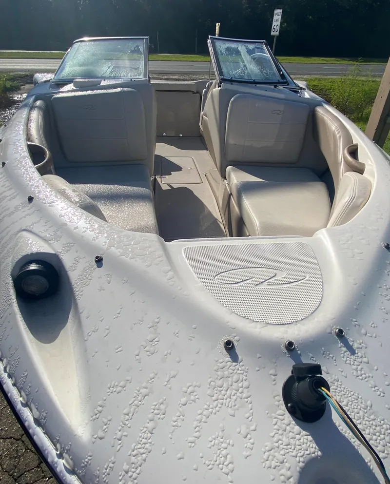 Slide: The Image of 2002 Regal 1900 LSR boat interior with seating and windshield, in sunlight. - 8
