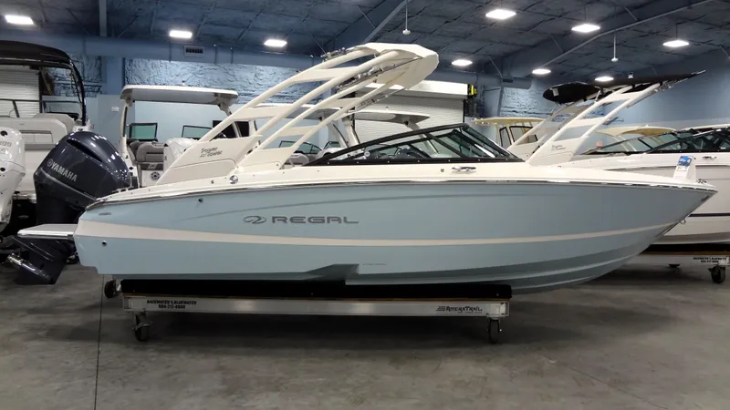 The Image of 2025 Regal LX2 boat in showroom, light blue hull, sleek design. - 0