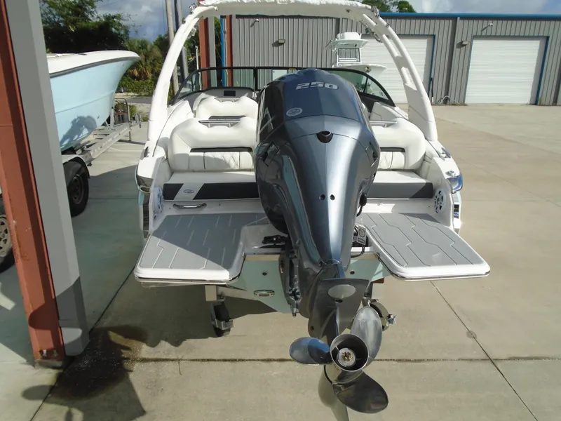 Slide: The Image of 2025 Regal LX2 boat with powerful outboard motor, parked on concrete surface. - 10