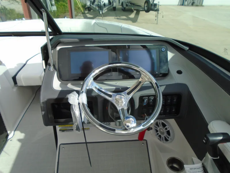 Slide: The Image of 2025 Regal LX2 boat dashboard with steering wheel and digital displays. - 13