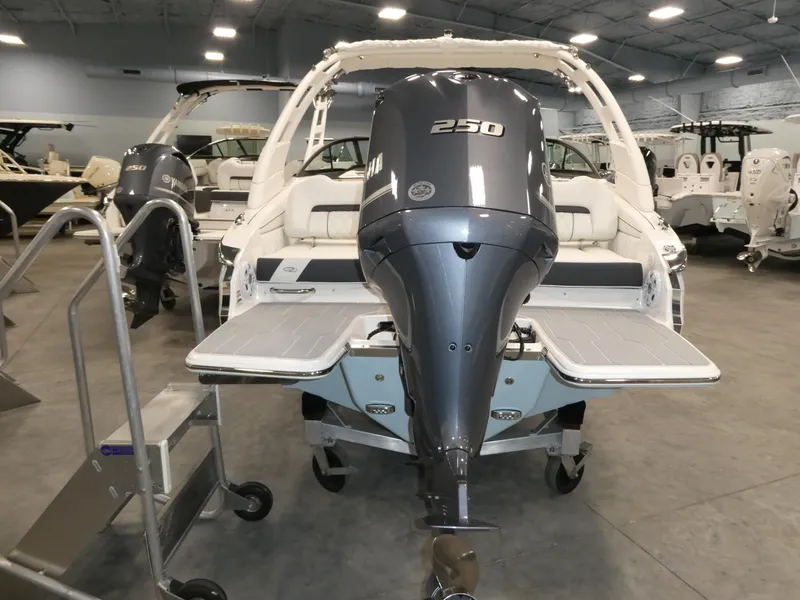 Slide: The Image of 2025 Regal LX2 boat with 250 HP engine in showroom setting. - 21