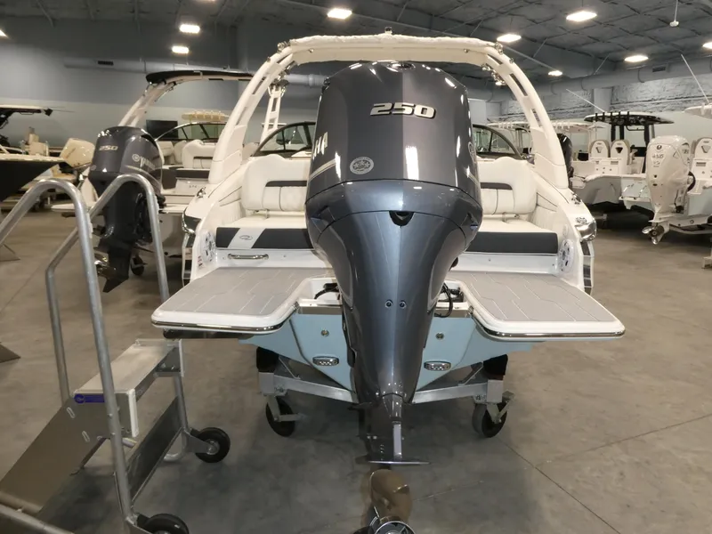 Slide: The Image of 2025 Regal LX2 boat with powerful 250 HP outboard motor in showroom. - 22