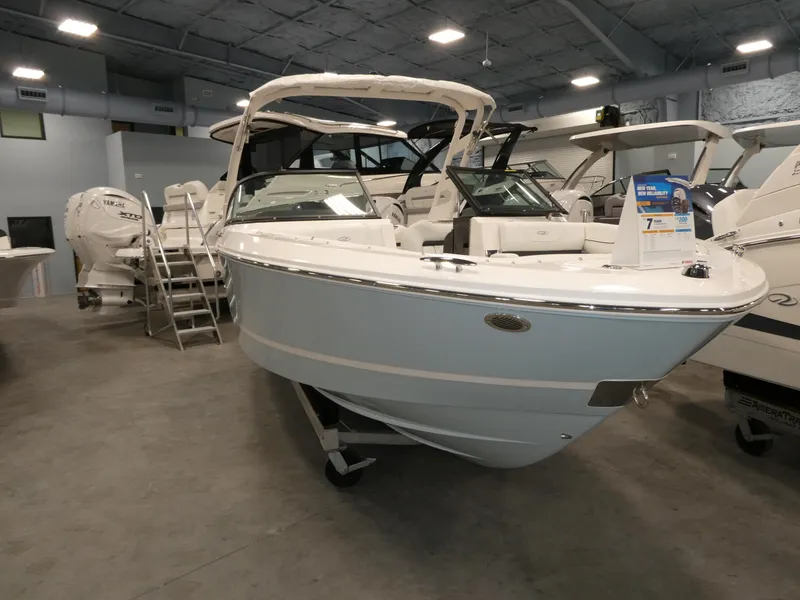 Slide: The Image of 2025 Regal LX2 boat displayed in a showroom, featuring sleek design and modern amenities. - 26