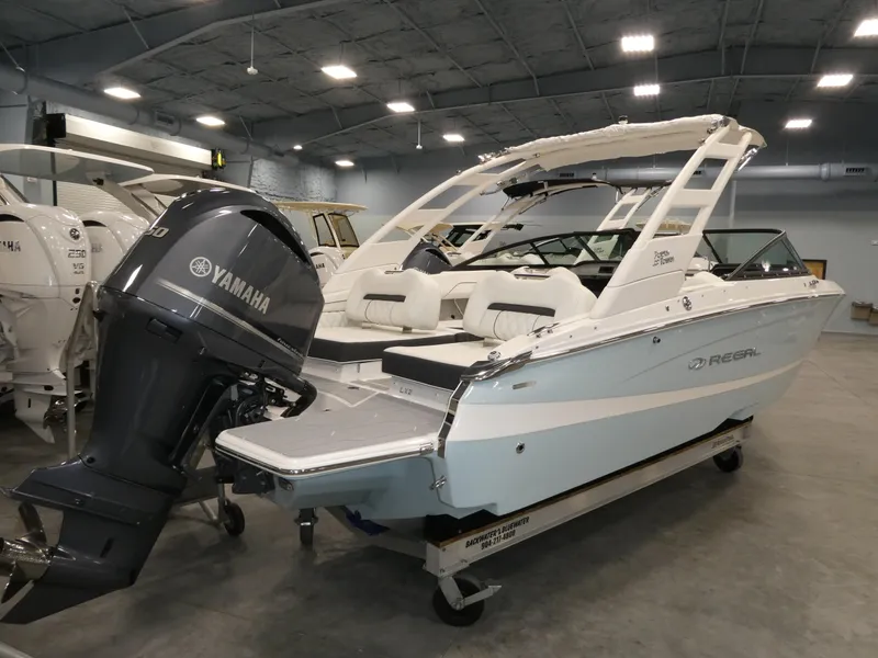 Slide: The Image of 2025 Regal LX2 boat with Yamaha engine in a showroom. - 4