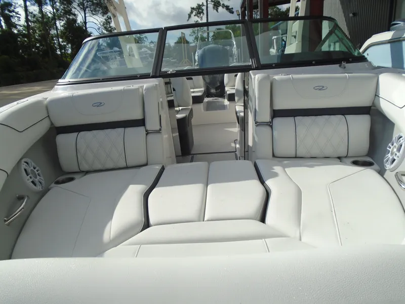 Slide: The Image of 2025 Regal LX2 boat interior with white leather seating and modern design. - 6