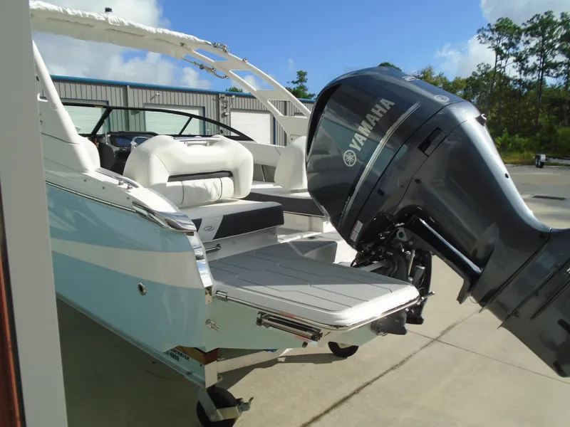 Slide: The Image of 2025 Regal LX2 boat with Yamaha outboard motor, docked outdoors. - 8