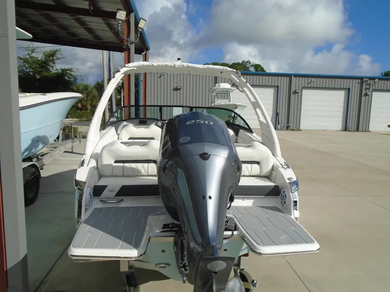 Slide: The Image of 2025 Regal LX2 boat with powerful outboard motor in a marina setting. - 9