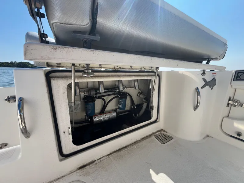 Slide: The Image of 2019 Wellcraft 262 Fisherman boat storage compartment with open hatch, showcasing interior equipment. - 11