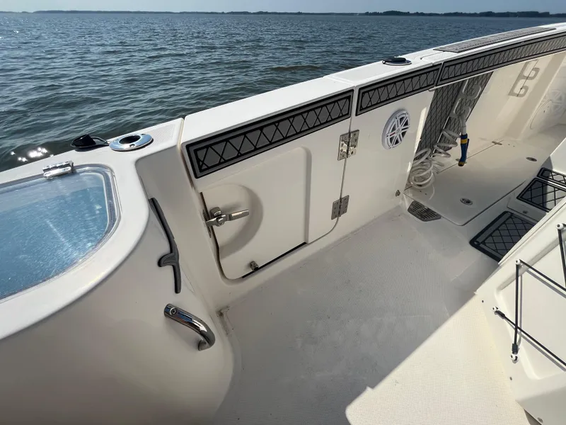 Slide: The Image of 2019 Wellcraft 262 Fisherman boat interior, featuring deck details and ocean view. - 12
