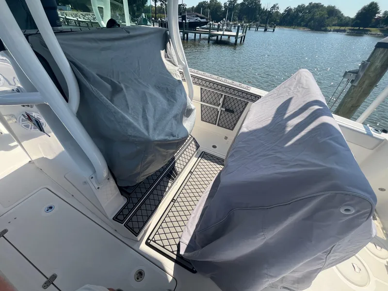 Slide: The Image of 2019 Wellcraft 262 Fisherman boat interior with covered seats by the water. - 16