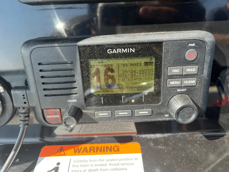 Slide: The Image of Garmin marine radio on 2019 Wellcraft 262 Fisherman boat dashboard with warning label. - 21
