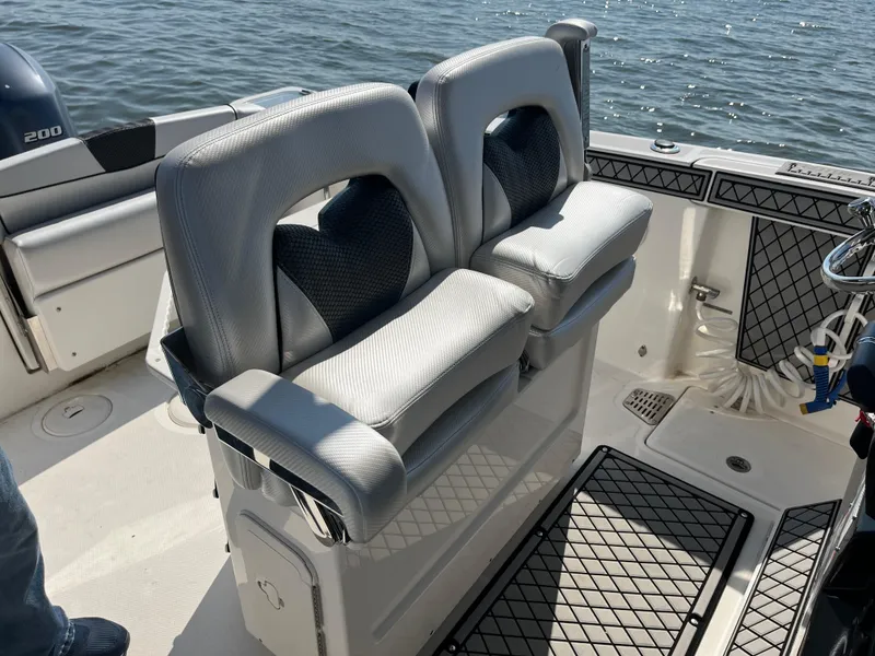 Slide: The Image of 2019 Wellcraft 262 Fisherman boat interior with dual cushioned seats and ocean view. - 25