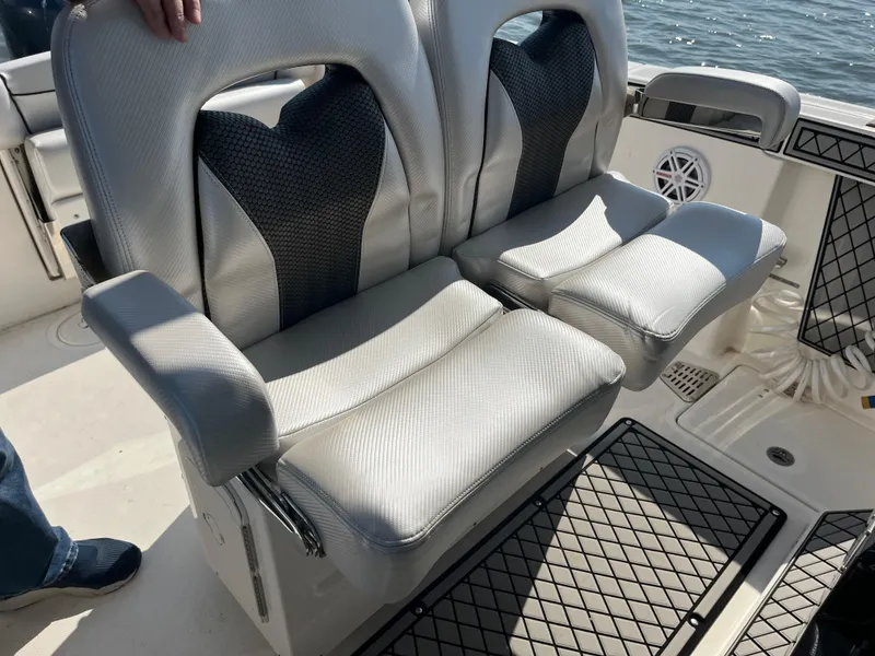 Slide: The Image of 2019 Wellcraft 262 Fisherman boat seats, featuring dual cushioned chairs with armrests on deck. - 26