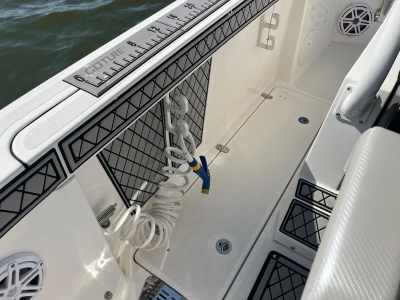 Slide: The Image of 2019 Wellcraft 262 Fisherman boat deck with coiled hose and ruler. - 27