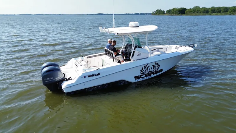 Slide: The Image of 2019 Wellcraft 262 Fisherman boat cruising on a calm lake. - 3