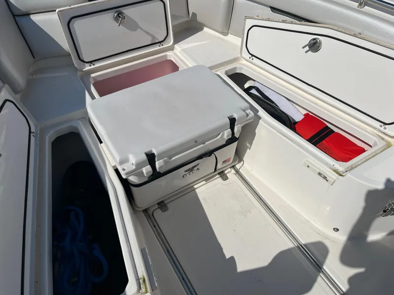 Slide: The Image of 2019 Wellcraft 262 Fisherman boat storage compartments with cooler and gear. - 31