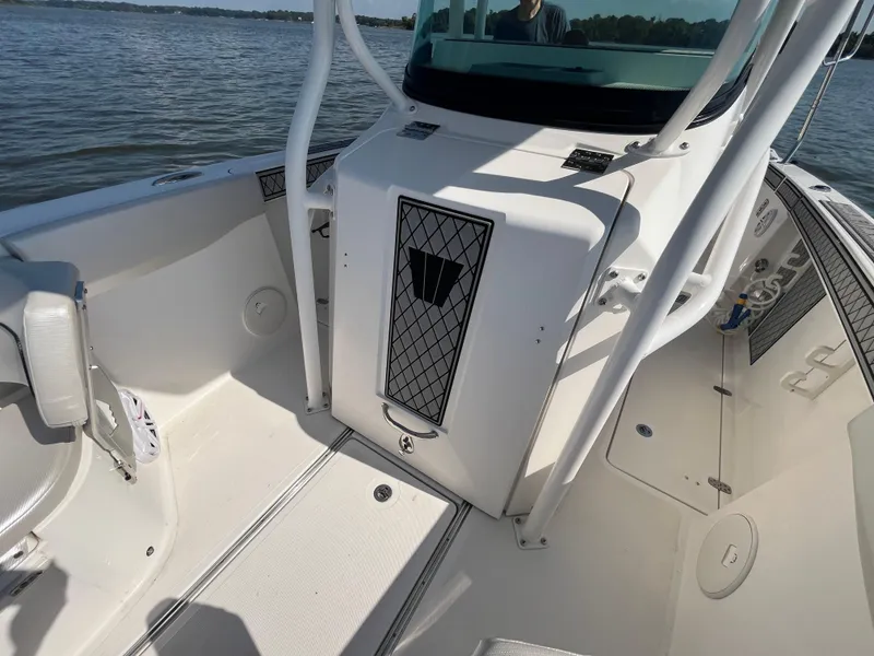 Slide: The Image of 2019 Wellcraft 262 Fisherman boat interior with white seating and storage compartments. - 33
