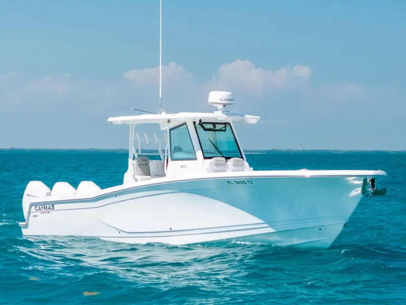 The Image of 2023 Caymas 341 CC boat cruising on clear blue ocean waters. - 0