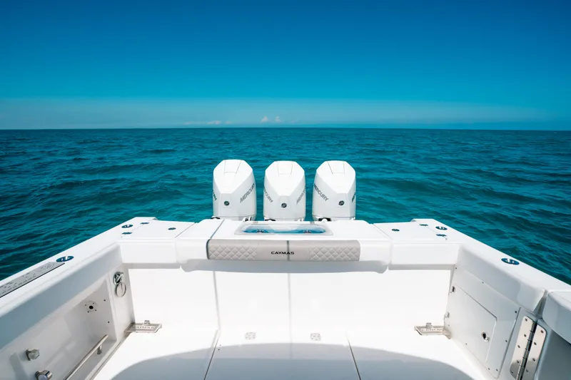 Slide: The Image of 2023 Caymas 341 CC boat with triple engines on open ocean. - 14