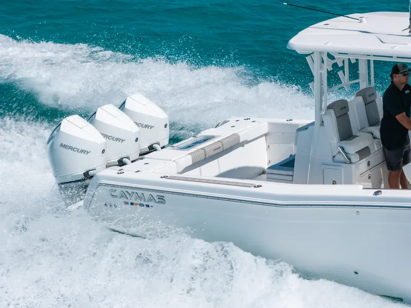 Slide: The Image of 2023 Caymas 341 CC boat cruising with powerful Mercury engines in clear blue waters. - 17