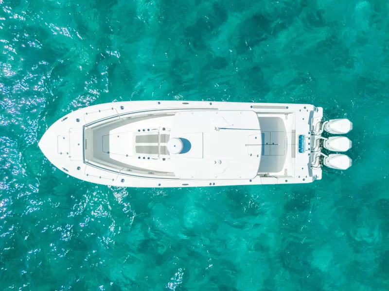 Slide: The Image of Aerial view of 2023 Caymas 341 CC boat on turquoise water. - 19