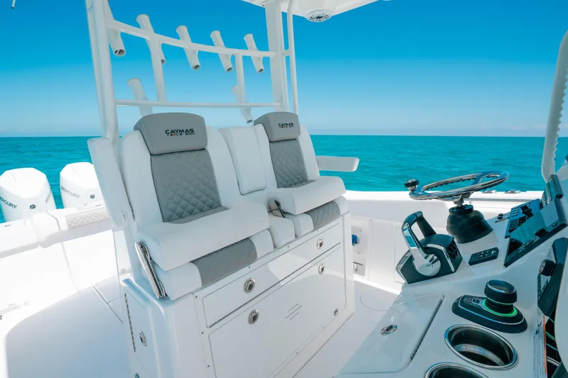 Slide: The Image of 2023 Caymas 341 CC boat interior with helm, seating, and ocean view. - 2