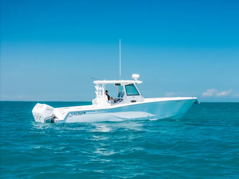 Slide: The Image of 2023 Caymas 341 CC boat cruising on clear blue ocean waters. - 21