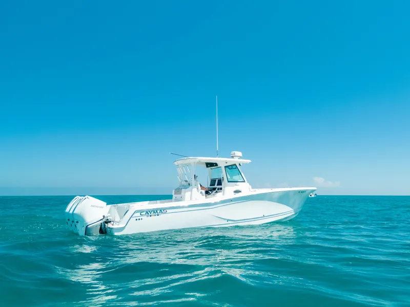 Slide: The Image of 2023 Caymas 341 CC boat on open sea under clear blue sky. - 22