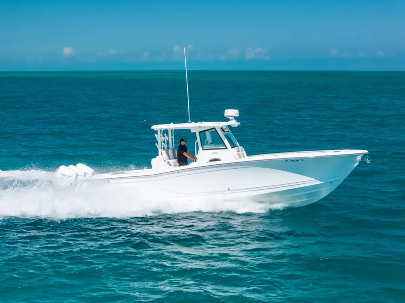 Slide: The Image of 2023 Caymas 341 CC boat cruising on open ocean waters. - 24