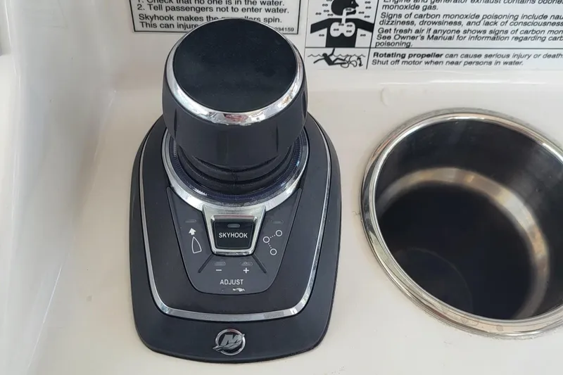 Slide: The Image of 2023 Caymas 341 CC boat control panel with joystick and cup holder. - 31