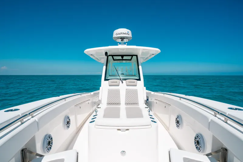 Slide: The Image of 2023 Caymas 341 CC boat on open sea under clear blue sky. - 6