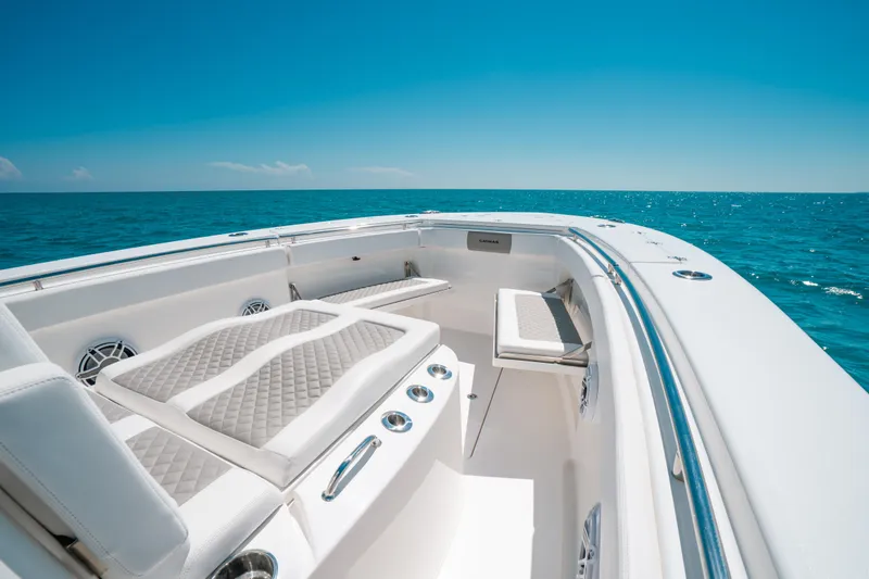 Slide: The Image of 2023 Caymas 341 CC boat interior with luxurious seating on open ocean. - 7