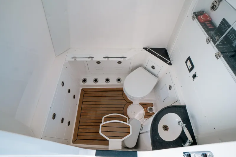 Slide: The Image of 2023 Caymas 341 CC boat interior with toilet, sink, and wooden flooring. - 9