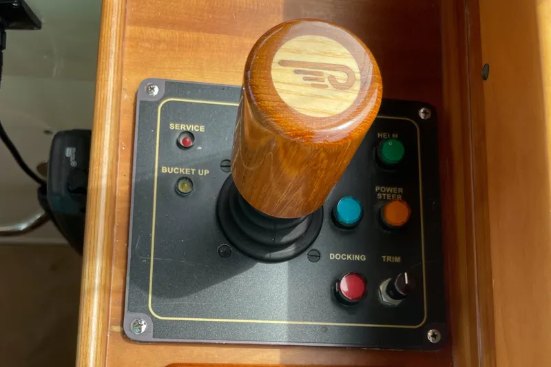Slide: The Image of Control panel of a 2007 Hinckley Talaria 44 Flybridge with wooden joystick and buttons. - 10