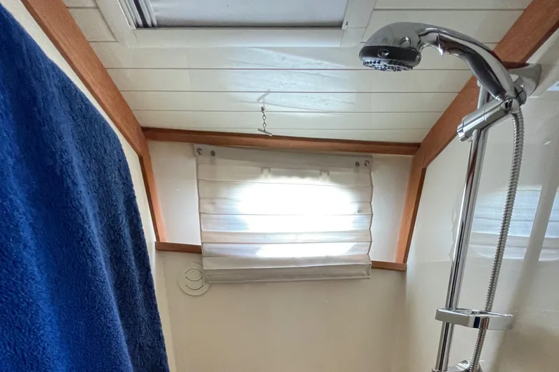 Slide: The Image of Shower area in 2007 Hinckley Talaria 44 Flybridge with blue towel and window. - 14