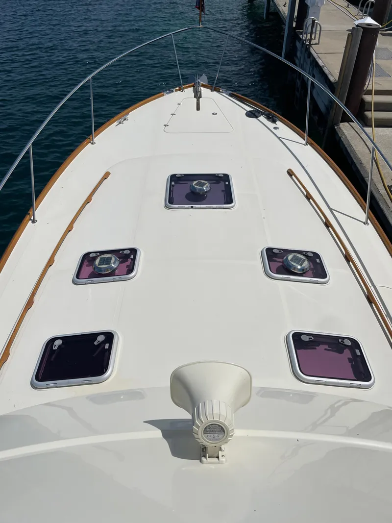 Slide: The Image of 2007 Hinckley Talaria 44 Flybridge yacht deck with hatches, docked by the water. - 15