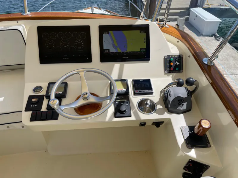 Slide: The Image of Helm of 2007 Hinckley Talaria 44 Flybridge with navigation screens and controls. - 5